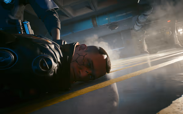 A cybernetically enhanced man lies on the ground, restrained by an officer, as smoke rises